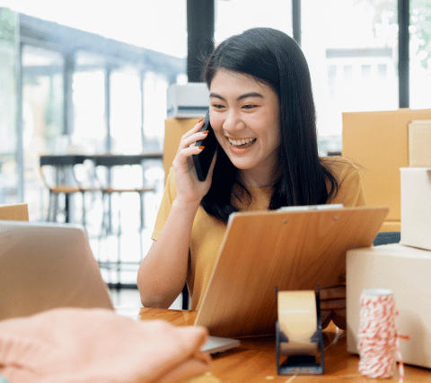 Woman holding a clipboard and talking on the phone