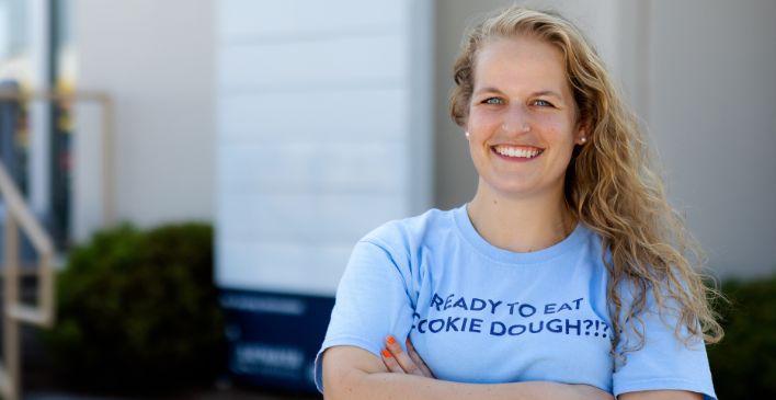 Smiling woman with arms crossed staring into the camera