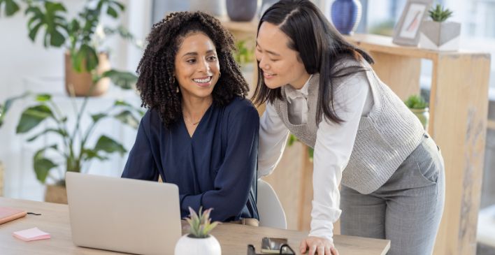 Two women talking in an office setting