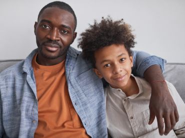 Man with his arm around a young boy