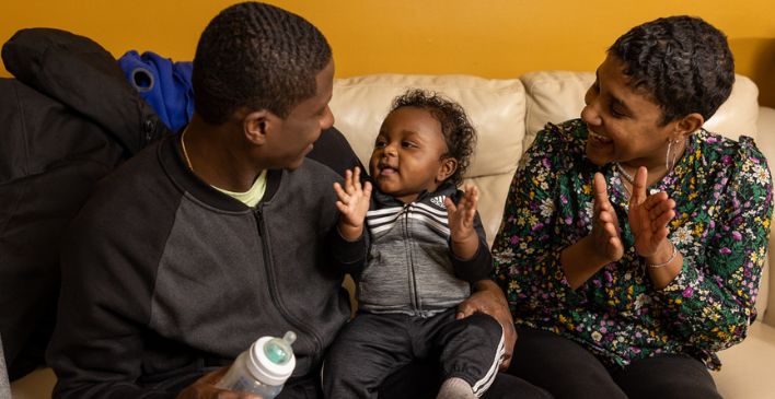 Parents clapping with their baby 