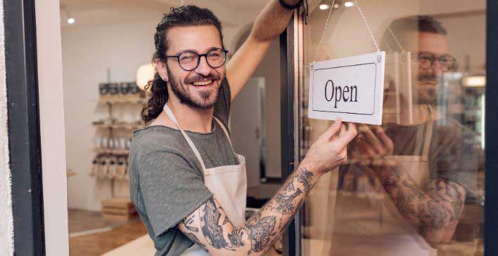 Man holding an open/close sign