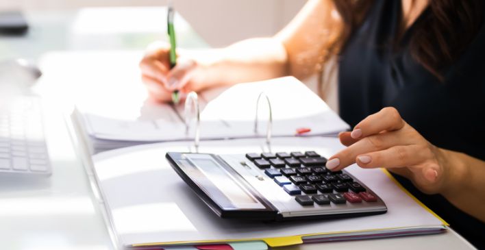 Person's hand pressing keys on a calculator