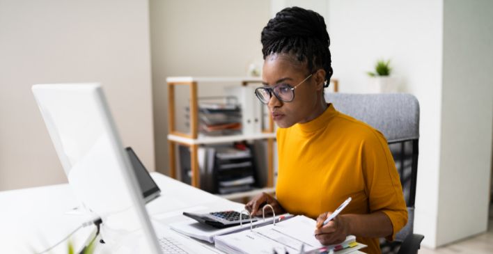 Woman at a desk working on a computer